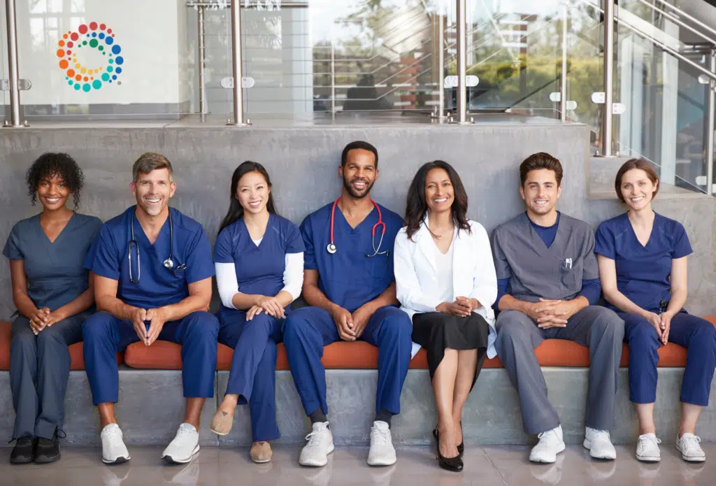 Groupd of happy clinicians sitting in a row