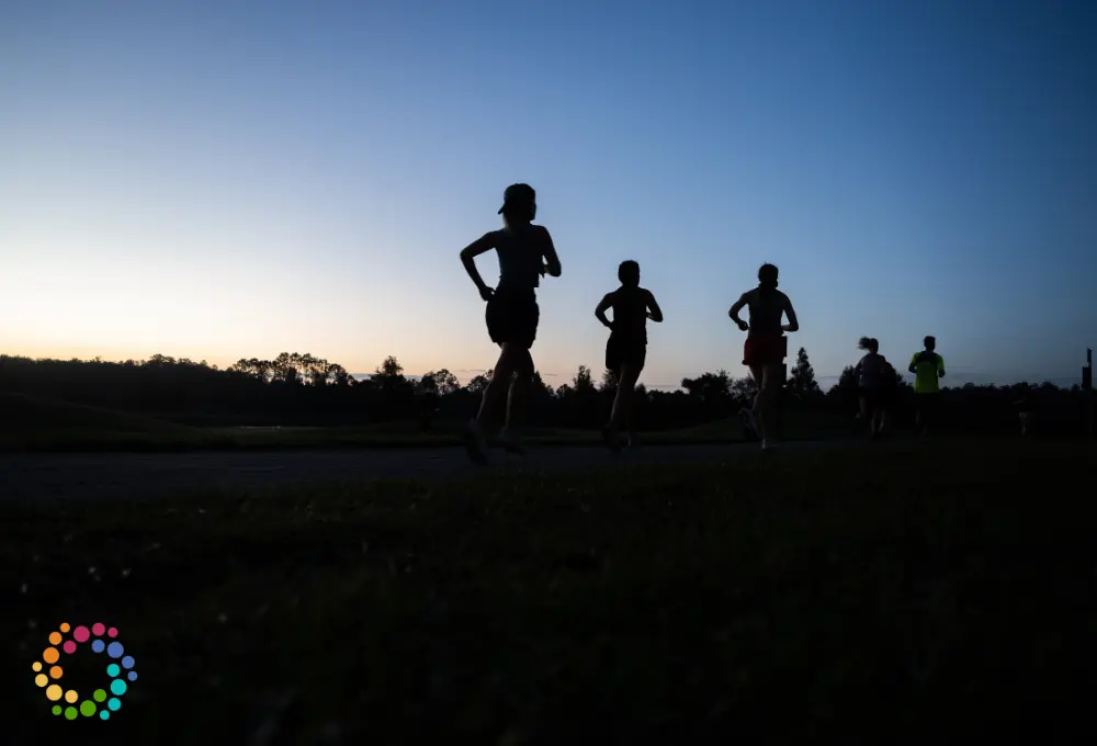 Runners jogging on a trail at dawn