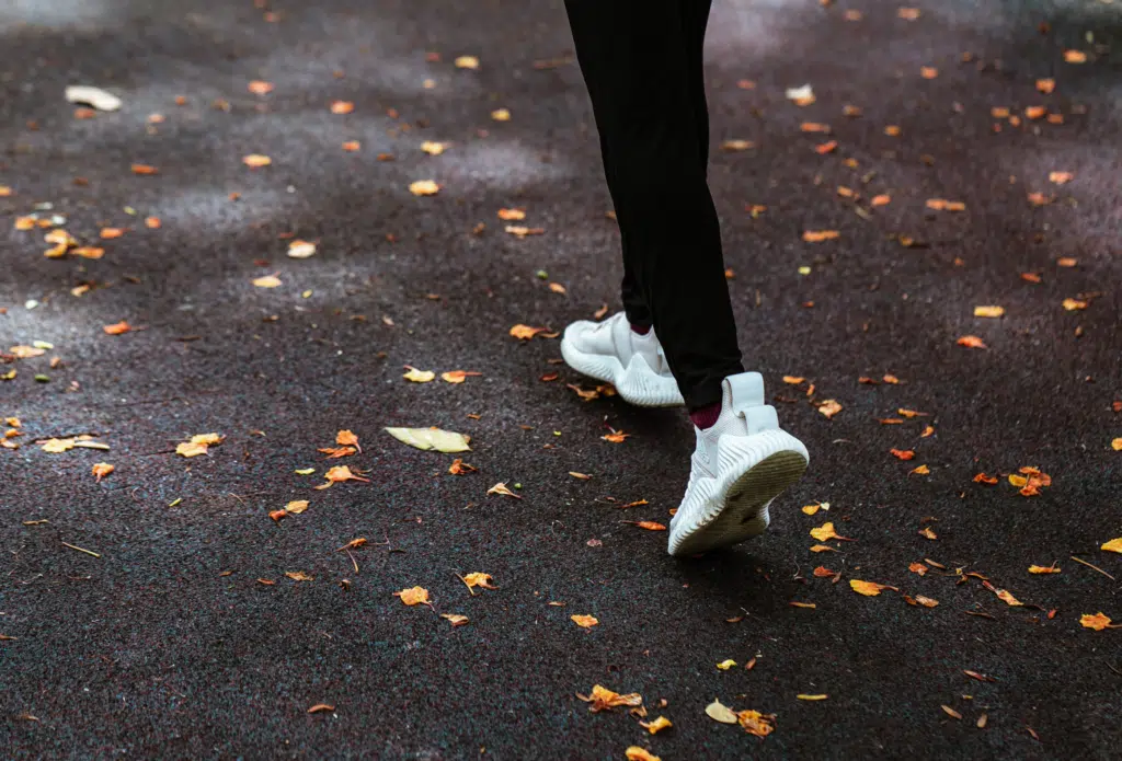 Close up of feet running on a road